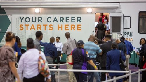 A low unemployment rate means most people who want jobs can eventually find one, but at any moment, many tens of thousands of Georgians are out of work and looking for their next position. Here, job seekers registered at a job fair held Oct. 8 at the Georgia International Convention Center. (Photo by Phil Skinner)