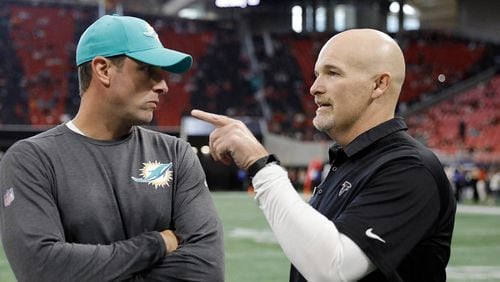 Miami Dolphins head coach Adam Gase speaks with Atlanta Falcons head coach Dan Quinn before the first half of an NFL football game, Sunday, Oct. 15, 2017, in Atlanta. (AP Photo/David Goldman)