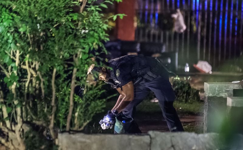 Atlanta police collect evidence after a man was found shot to death on a sidewalk in northwest Atlanta.