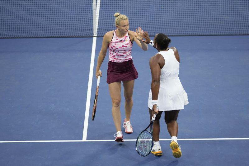 Katerina Siniakova, of the Czech Republic, and Taylor Townsend, of the United States, react during a second round match of the U.S. Open tennis championships, Thursday, Aug. 29, 2024, in New York. (AP Photo/Frank Franklin II)