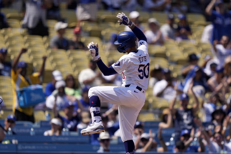 Los Angeles Dodgers' Mookie Betts gestures toward his dugout after hitting a triple during the fourth inning of a baseball game against the Cleveland Guardians, Sunday, Sept. 8, 2024, in Los Angeles. (AP Photo/Mark J. Terrill)