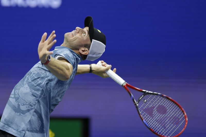 Tommy Paul, of the United States, serves to Jannik Sinner, of Italy, during a fourth round match of the U.S. Open tennis championships, Monday, Sept. 2, 2024, in New York. (AP Photo/Adam Hunger)