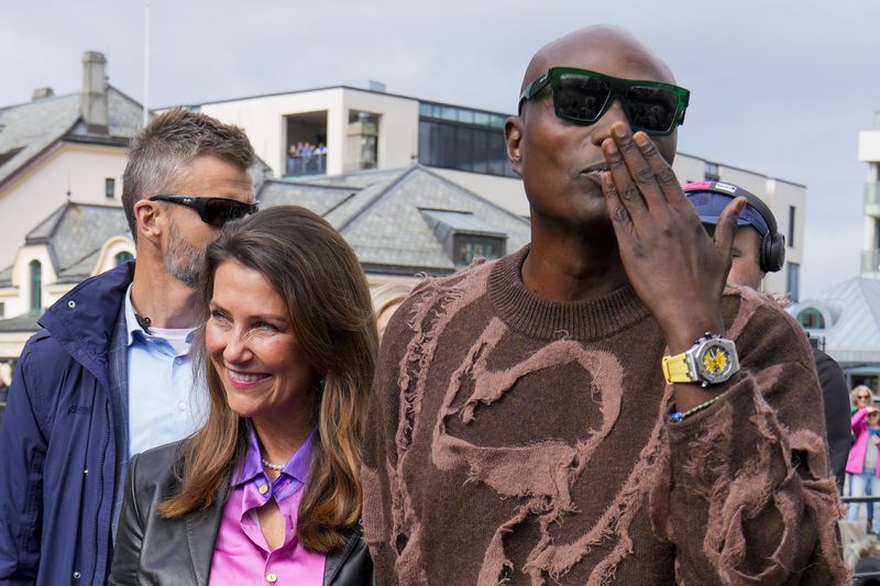 Norway's Princess Martha Louise and Durek Verret arrive at the boats in Alesund, Norway, Friday Aug. 30, 2024. that will transport them to Geiranger for their wedding celebration on Saturday. (Heiko Junge/NTB via AP)