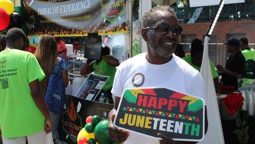 Brett Ringer, of Atlanta, welcomes people to the Photoboss 360 ATL photo booth during the 21st Annual Cobb NAACP Juneteenth Celebration in Marietta on Sunday. (Photo Courtesy of Isabelle Manders)