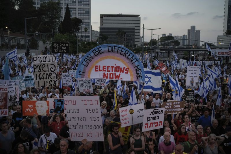 People attend a protest against Israeli Prime Minister Benjamin Netanyahu's government and demanding elections, in Tel Aviv, Israel, Saturday, June 22, 2024. (AP Photo/Leo Correa)