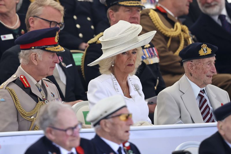 King Charles III, Queen Camilla and Veteran Richard Trelease attend the UK Ministry of Defence and the Royal British Legion's commemorative event at the British Normandy Memorial to mark the 80th anniversary of D-Day Thursday, June 06, 2024 in Ver-Sur-Mer, France. Normandy is hosting various events across significant sites such as Pegasus Bridge, Sainte-Mère-Église, and Pointe du Hoc, to officially commemorate the 80th anniversary of the D-Day landings that took place on June 6, 1944. (Chris Jackson/Pool photo via AP)