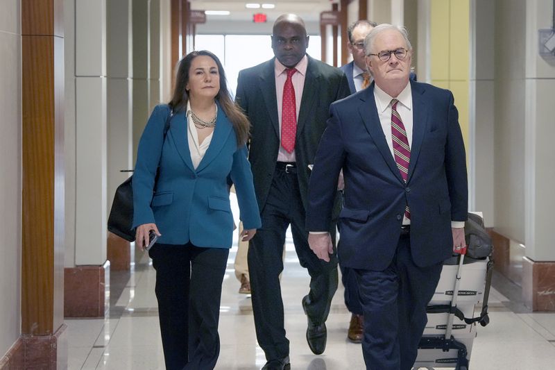 Retired Houston Police Department officer Gerald Goines, center, and his defense team arrive at 482nd District Court for his trial on two felony murder charges in the January 2019 deaths of Dennis Tuttle and Rhogena Nicholas, Monday, Sept. 9, 2024 at Harris County Criminal Courthouse in Houston. (Yi-Chin Lee/Houston Chronicle via AP)