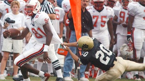 Sandy Creek receiver Calvin Johnson (81) gets away from a Fayette County defender for a first down during a game Friday, Sept. 5, 2003, in Fayetteville.  (Marlene Karas/AJC)