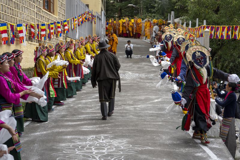 Exiled Tibetans in costumes practice a traditional dance to welcome their spiritual leader the Dalai Lama before he arrives in Dharamshala, India, Wednesday, Aug. 28, 2024. (AP Photo/Ashwini Bhatia)