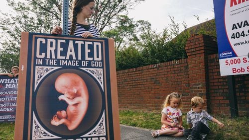 Operation Save America organizers protest Friday outside of an abortion clinic in Forest Park. (Olivia Bowdoin for The Atlanta Journal-Constitution)