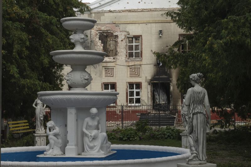 A fountain is seen against a background of a damaged building in central Sudzha, Kursk region, Russia, Friday, Aug. 16, 2024. This image was approved by the Ukrainian Defense Ministry before publication. (AP Photo)