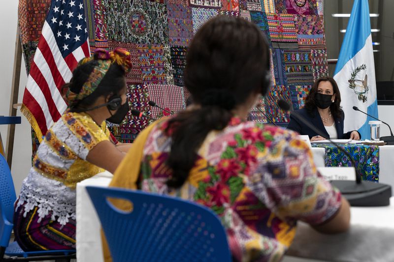 FILE - Vice President Kamala Harris, right, smiles as women speak to her about their businesses during a meeting with Guatemalan women entrepreneurs and innovators at the Universidad del Valle de Guatemala, Monday, June 7, 2021, in Guatemala City. (AP Photo/Jacquelyn Martin, File)