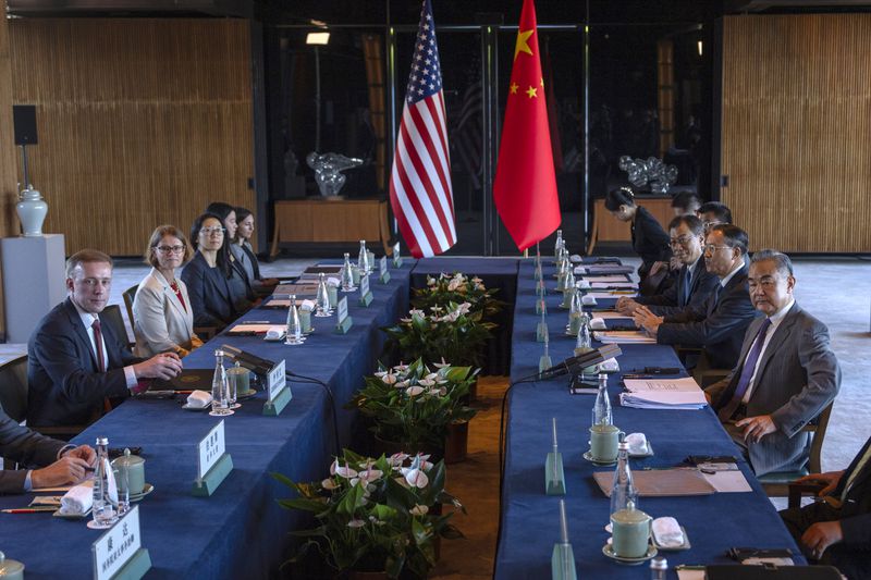 Wang Yi, right, the director of the Communist Party's Central Foreign Affairs Commission Office and White House national security adviser Jake Sullivan, left, pose for photos before their talk at Yanqi lake in Beijing, Tuesday, Aug. 27, 2024. (AP Photo/Ng Han Guan, Pool)