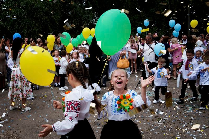 First-grades attend the traditional ceremony for the first day of school in Zaporizhzhia, Ukraine, Sunday Sept. 1, 2024. Zaporizhzhia schoolchildren celebrated the traditional first day of school near the frontline. With the front just 40 kilometers away, the war is never far from the minds of teachers and families. (AP Photo/Evgeniy Maloletka)