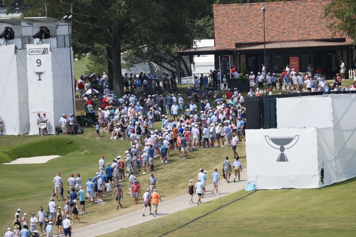 Fans walk near the ninth green during the final round of the Tour Championship at East Lake Golf Club on Sunday, Sept. 1, 2024, in Atlanta. 
(Miguel Martinez / AJC)