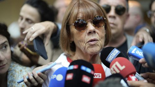 FILE - Gisele Pelicot speaks to media as she leaves the Avignon court house, southern France, Thursday, Sept. 5, 2024. (AP Photo/Lewis Joly, File)