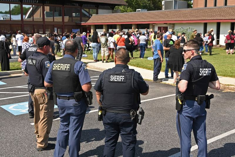 Members of the Harford County Sheriff's department stand outside of the Good Shepherd Presbyterian Church as families are reunited after students were evacuated from Joppatowne High School after a shooting at the school, Friday, Sept. 6, 2024, in Joppatowne, Maryland. (Lloyd Fox/The Baltimore Sun via AP)