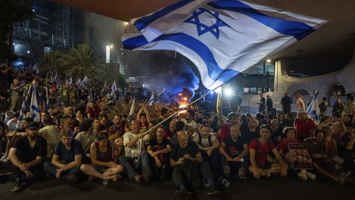 People block a road as they protest, calling for a deal for the immediate release of hostages held in the Gaza Strip by Hamas, in Tel Aviv, Israel, Sunday, Sept. 1, 2024. (AP Photo/Ohad Zwigenberg)