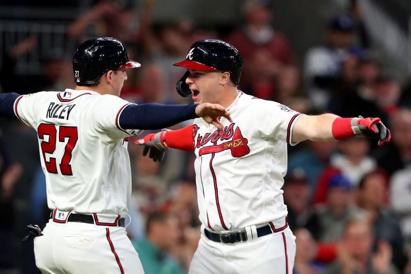 Braves rightfielder Joc Pederson celebrates hitting a two-run home run with teammate Austin Riley (27)  during the fourth inning of Game 2 of the NLCS Sunday, Oct. 17, 2021, against the Los Angeles Dodgers at Truist Park in Atlanta. (Curtis Compton / curtis.compton@ajc.com)