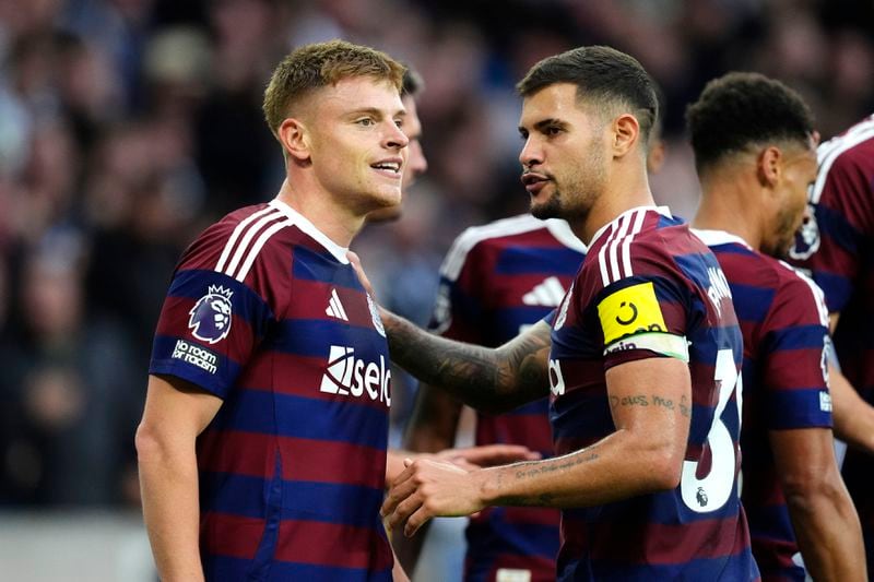 Newcastle United's Harvey Barnes (left) celebrates scoring his side's second goal of the game with team-mates during the British Premier League soccer match between Wolverhampton Wanderers and Newcastle United, at Molineux Stadium, Wolverhampton, England, Sunday, Sept. 15, 2024. (Nick Potts/PA via AP)