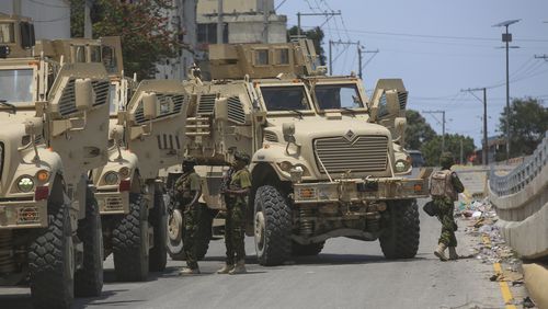 Kenyan police officers, part of a UN-backed multinational, work to tow away a broken down armored car during an operation in the Delmas neighborhood of Port-au-Prince, Haiti, Wednesday, Sept. 4, 2024. (AP Photo/Odelyn Joseph)