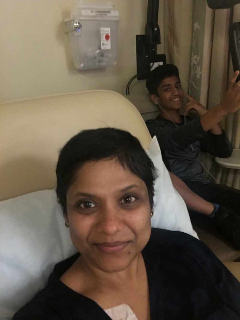 Dr. Sowmya Siragowni was diagnosed with stage 4 ovarian cancer five years ago. Here she is getting chemotherapy. In the background is her son, Vaden Tekkam.  Courtesy of Dr. Sowmya Siragowni