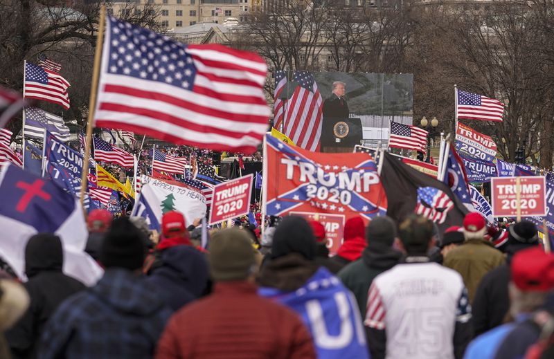 FILE - An Appeal To Heaven flag, center left, is pictured as people attend a rally in Washington, Jan. 6, 2021, in support of President Donald Trump. Supreme Court Justice Samuel Alito is embroiled in a second flag controversy, this time over the “Appeal to Heaven” flag, a banner that in recent years has come to symbolize Christian nationalism and the false claim that the 2020 presidential election was stolen. The flag was seen outside his New Jersey beach home last summer. (AP Photo/Carolyn Kaster, File)