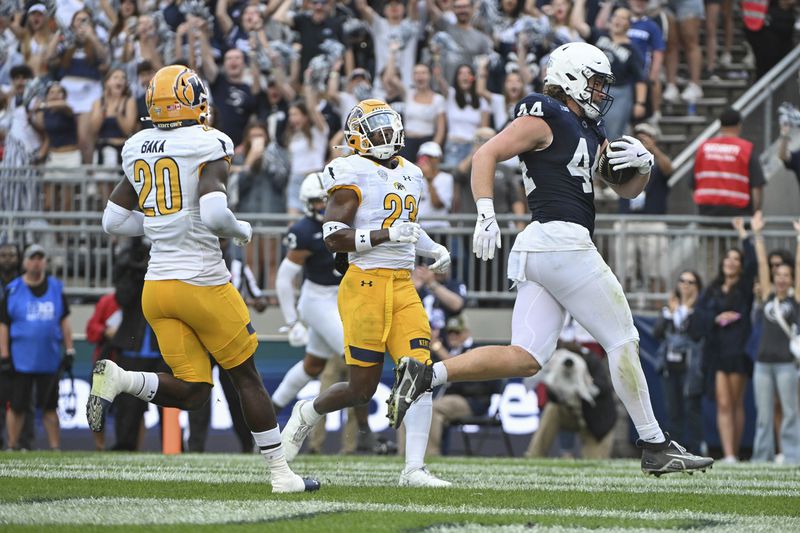 Penn State tight end Tyler Warren (44) scores a touchdown in front of Kent State defenders Naim Muhammad (23) and Josh Baka (20) during the first quarter of an NCAA college football game, Saturday, Sept. 21, 2024, in State College, Pa. (AP Photo/Barry Reeger)