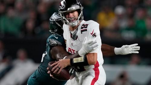 Atlanta Falcons quarterback Kirk Cousins is stopped by Philadelphia Eagles defensive end Brandon Graham (55) during the first half of an NFL football game Monday, Sept. 16, 2024, in Philadelphia. (AP Photo/Matt Rourke)