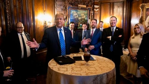 Former President Donald Trump made his aide Brian Jack, now running in Georgia's 3rd Congressional District, his first endorsement after effectively winning the GOP's presidential nomination on Super Tuesday. Brian Jack is standing on the right, wearing the black jacket with a blue tie, in this photo from a watch party Tuesday at Trump's Mar-a-Lago club. (Doug Mills/The New York Times)