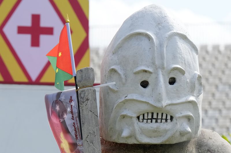 An Asaro mudman wears his mask as he stand in front of the stage as Pope Francis gives an address during meeting with young people in the Sir John Guise Stadium in Port Moresby, Papua New Guinea, Monday, Sept. 9, 2024. (AP Photo/Mark Baker)