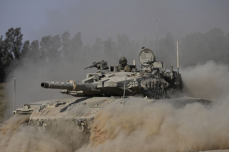 An Israeli tank maneuvers near the Israel-Gaza border in southern Israel, Friday, July 12, 2024. (AP Photo/Tsafrir Abayov)