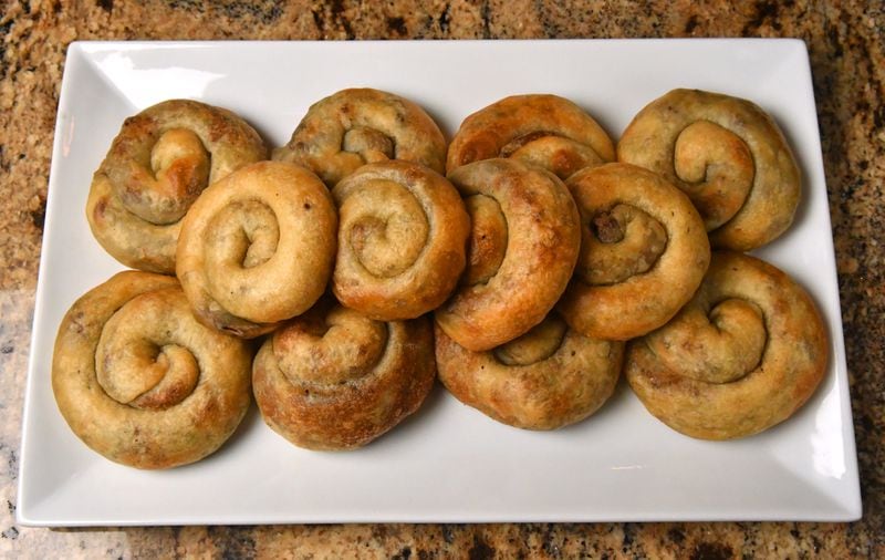 The mother of sisters Farrah Haidar and Hala Yassine was known for her Sfeeha. Their mother, Maha, died last year, so it's up to the sisters to carry on the tradition of making Maha's Spiral Meat Pies. (Styling by Farrah Haidar and Hala Yassine / Chris Hunt for the AJC)