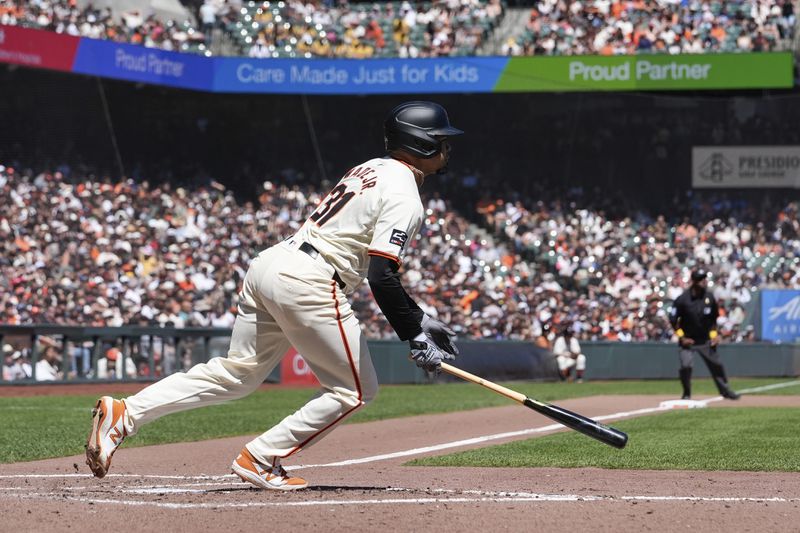 San Francisco Giants' LaMonte Wade Jr. runs after hitting a ground ball to Miami Marlins first baseman David Hensley during the third inning of a baseball game Sunday, Sept. 1, 2024, in San Francisco. Giants' Michael Conforto scored and Matt Chapman was out at second on the play. (AP Photo/Godofredo A. Vásquez)