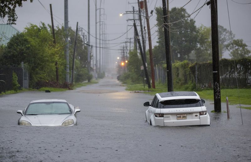 FILE - Two vehicle on Olive Street are flooded during Hurricane Francine in New Orleans, Wednesday, Sept. 11, 2024. (David Grunfeld/The Times-Picayune/The New Orleans Advocate via AP)