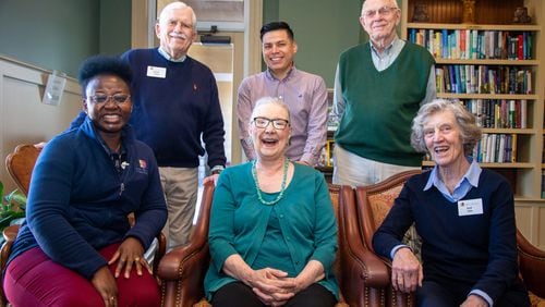 Juliet Bakare (counterclockwise from left), Barbara Cooper, Pat Shea, Don Sapit, Jose Pliego and Ross Lenhart pose together in the Park Springs library. Residents of Park Springs, a senior community in Stone Mountain, voluntarily give money to a Foundation that funds college scholarships for employees or their family members.  PHIL SKINNER FOR THE ATLANTA JOURNAL-CONSTITUTION.