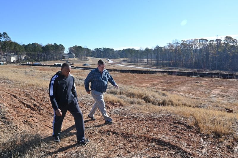 “We were all blindsided when they started cutting down trees,” says Parkview Estates homeowner Mike Donithan, right. Some homeowners, considering the impact of the expansion of rental houses on their own assets, have already headed for the exits. (Hyosub Shin / Hyosub.Shin@ajc.com)