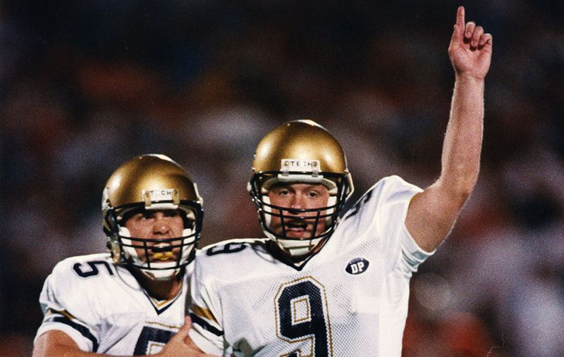 Georgia Tech kicker Scott Sisson (9) and holder Scott Aldredge (5) celebrate Sisson's game-winning, 37-yard field goal with 7 seconds left in the game to settle a frantic 41-38 come-from-behind victory over the top-ranked Cavaliers.