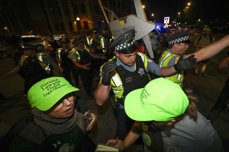 Police move protesters during a demonstration near the Democratic National Convention Thursday, Aug. 22, 2024, in Chicago. (AP Photo/Julio Cortez)