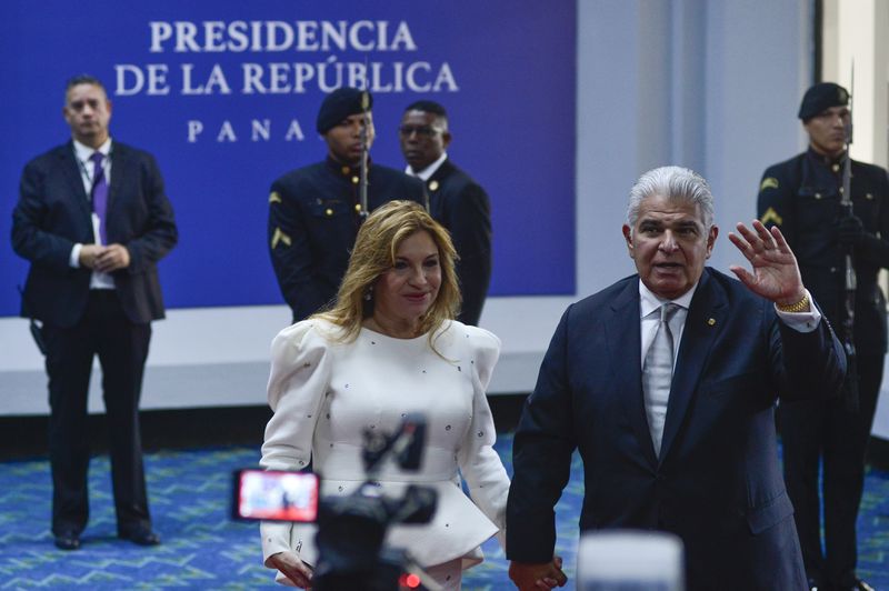 Panamanian President-elect Jose Raul Mulino waves to the press alongside wife Maricel Cohen de Mulino as they arrive at his swearing-in ceremony at the Atlapa Convention Centre in Panama City, Monday, July 1, 2024. (AP Photo/Agustin Herrera)