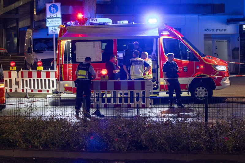 Emergency services and police are deployed near the scene where people were killed and injured in an attack at a festival in Solingen, western Germany, the German dpa news agency reported, Friday, Aug. 23, 2024. (Gianni Gattus/dpa via AP)