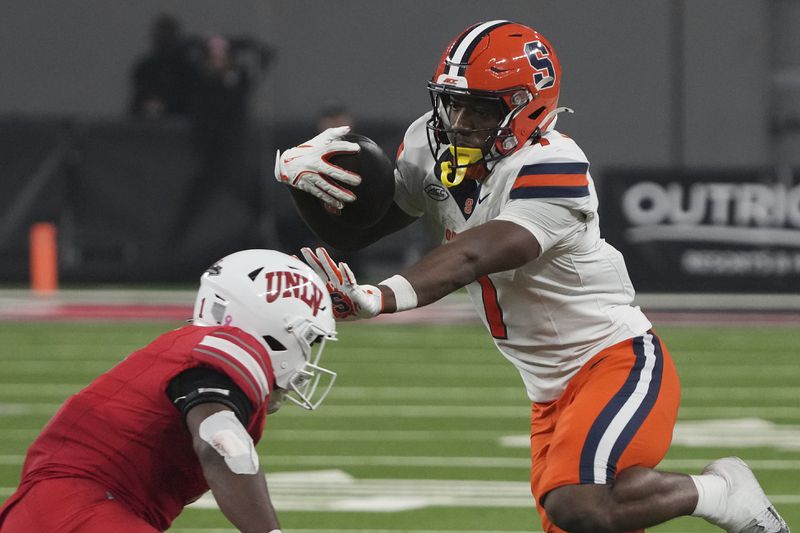 Syracuse wide receiver Jackson Meeks (7) stiff arms UNLV defensive back Jalen Catalon in the second half during an NCAA college football game, Friday, Oct. 4, 2024, in Las Vegas. (AP Photo/Rick Scuteri)