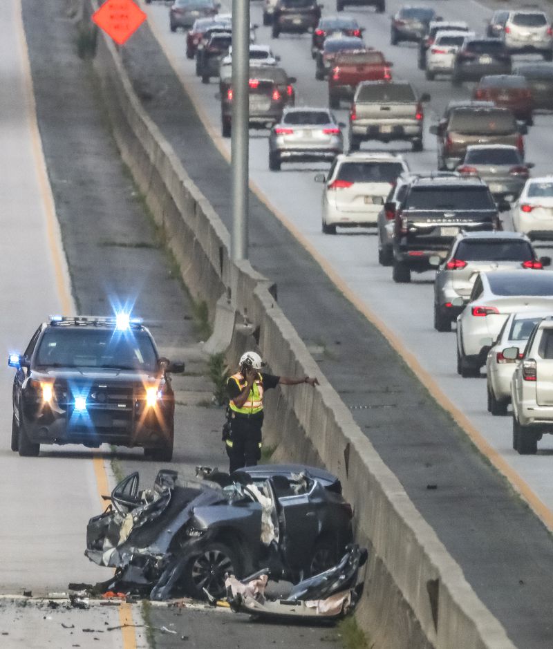 A fatal crash blocked all northbound lanes of Ga. 400 at Holcomb Bridge Road in Roswell last June. A spokesperson for the Governors Highway Safety Association says that the U.S. is experiencing "a traffic safety crisis," and that "we must do more of everything that works to better protect everyone on the road, both inside and outside a vehicle." (John Spink / John.Spink@ajc.com)