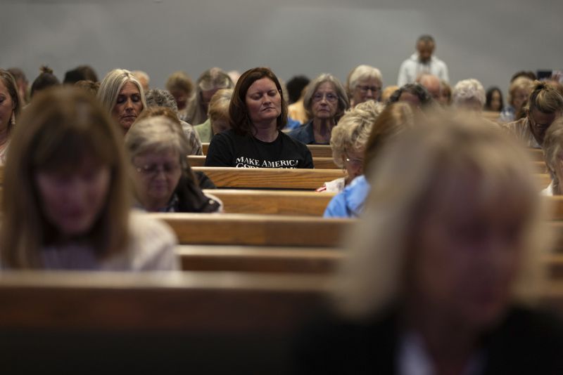 Audience members listen as Pastor Jack Hibbs delivers a prayer at a Comeback California Tour event at Revival Fellowship, Saturday, Sept. 21, 2024, in Menifee, Calif. (AP Photo/Zoë Meyers)