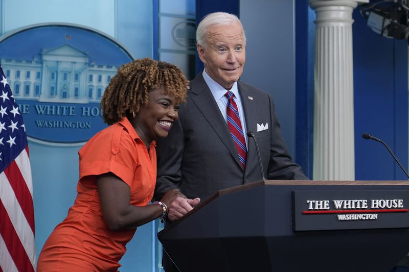 President Joe Biden shares a laugh with White House press secretary Karine Jean-Pierre when Biden made a surprise appearance during the daily briefing at the White House in Washington, Friday, Oct. 4, 2024. (AP Photo/Susan Walsh)