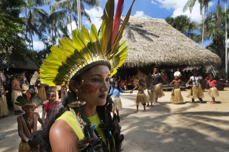 Apolima-Arara Indigenous youth Ozileia Macedo dances during the annual celebration recognizing the Ashaninka territory in the Apiwtxa village, Acre state, Brazil, Monday, June 24, 2024. (AP Photo/Jorge Saenz)