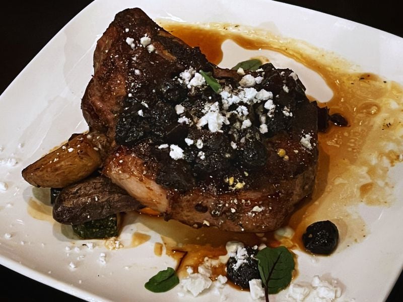 The Ashford's dry-aged pork chop packs a huge punch of flavor. Henri Hollis/henri.hollis@ajc.com