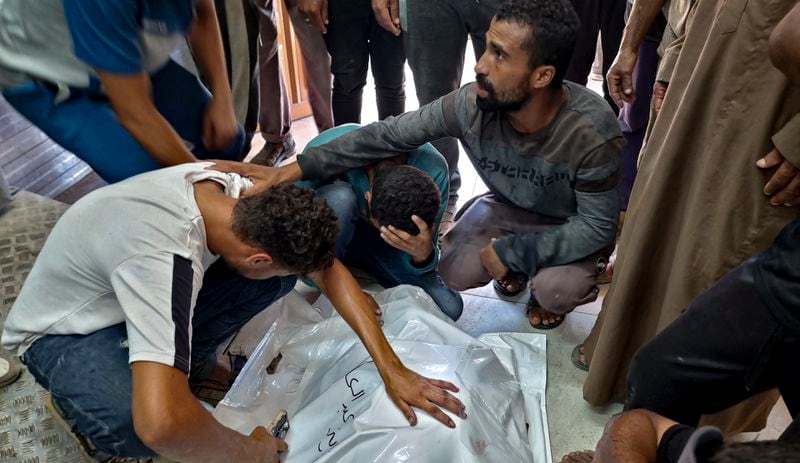 Palestinians mourn a relative killed in the Israeli bombardment of the Gaza Strip, at a hospital in Khan Younis, Saturday, Aug. 24, 2024. (AP Photo/ Mohammad Jahjouh)