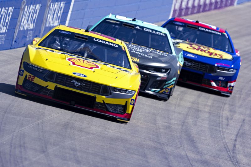 Joey Logano (22) leads Austin Dillon and Noah Gragson during a NASCAR Cup Series auto race, Sunday, June 30, 2024, in Gladeville, Tenn. (AP Photo/Wade Payne)