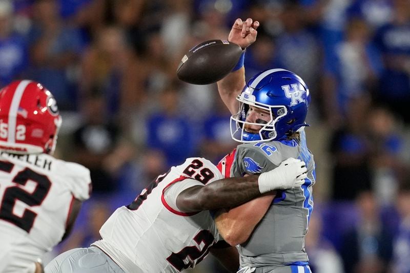 Kentucky quarterback Brock Vandagriff fumbles as he's hit by Georgia linebacker Gabe Harris Jr. (29) during the first half of an NCAA college football game, Saturday, Sept. 14, 2024, in Lexington, Ky. (AP Photo/Darron Cummings)